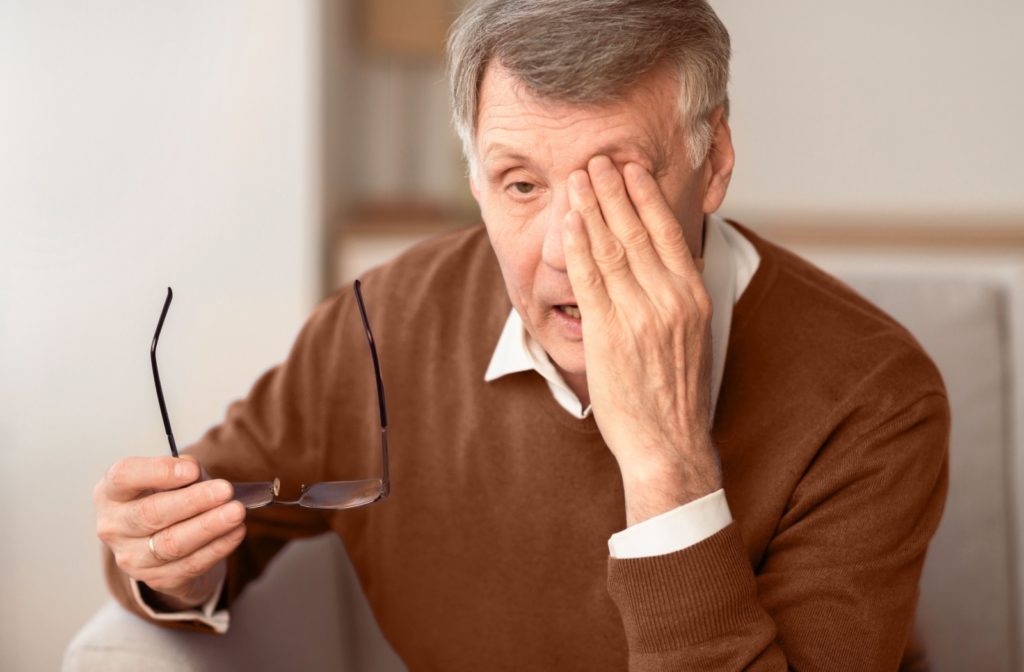 a older person rubbing their eyes due to unilateral glaucoma symptoms