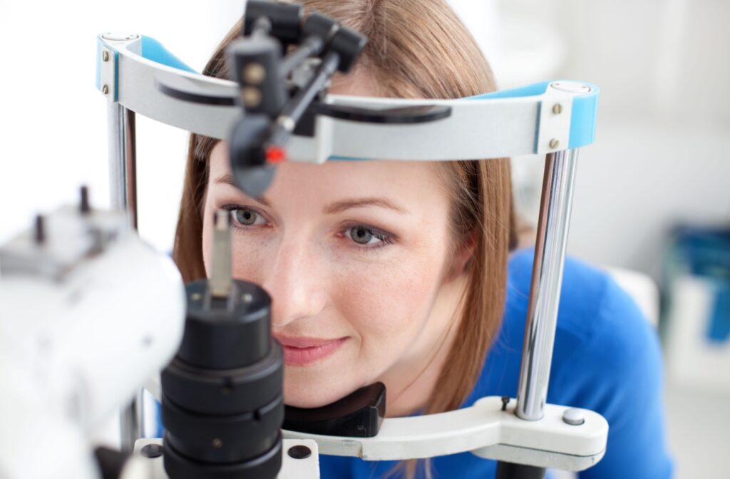 A close up of a patient having their eyes assessed with a slit lamp during an eye exam.