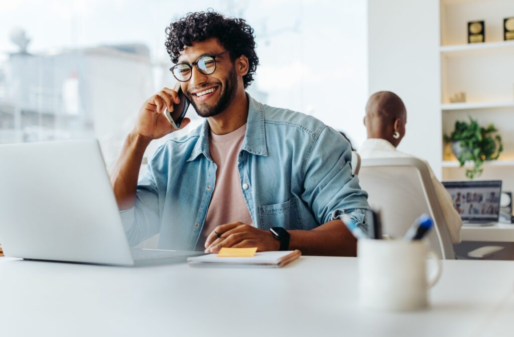 A person working on a laptop, wearing glasses to help reduce eye fatigue and strain from screen time.