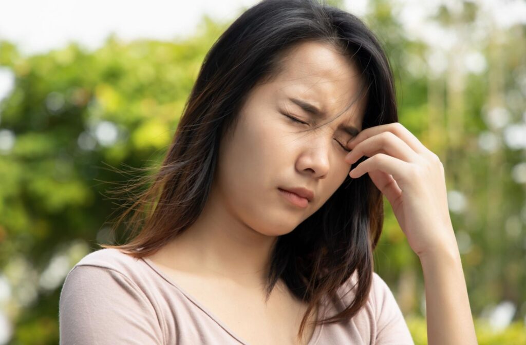 A person squeezing their eyes closed due irritation and burning sensation.